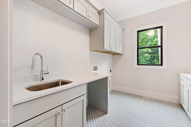 clothes washing area featuring hookup for an electric dryer, cabinets, hookup for a washing machine, and sink