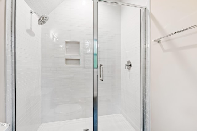 bathroom with a shower with door