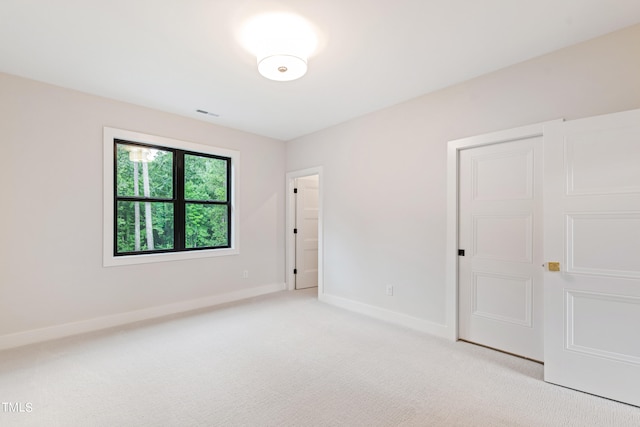 unfurnished bedroom with light colored carpet