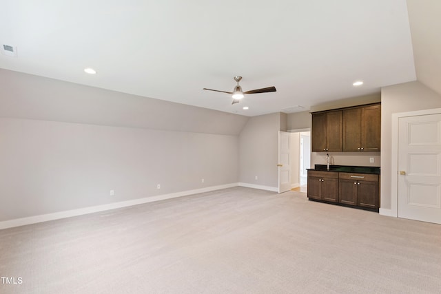 unfurnished living room with light carpet, lofted ceiling, and ceiling fan