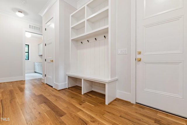 mudroom featuring ornamental molding and light wood-type flooring