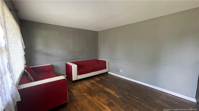 unfurnished room with wood finished floors and baseboards