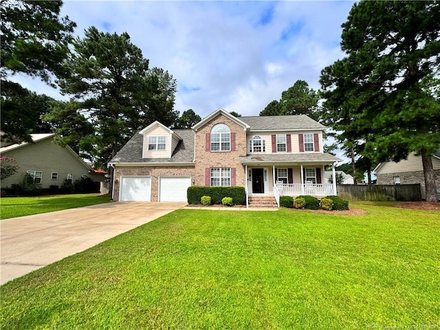 colonial-style house featuring a garage, a porch, and a front lawn