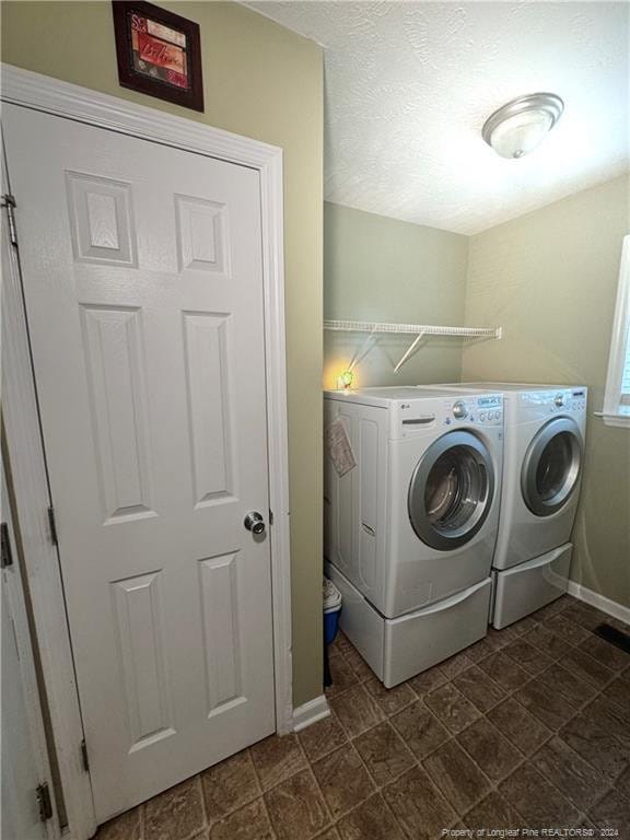 clothes washing area with washer and dryer