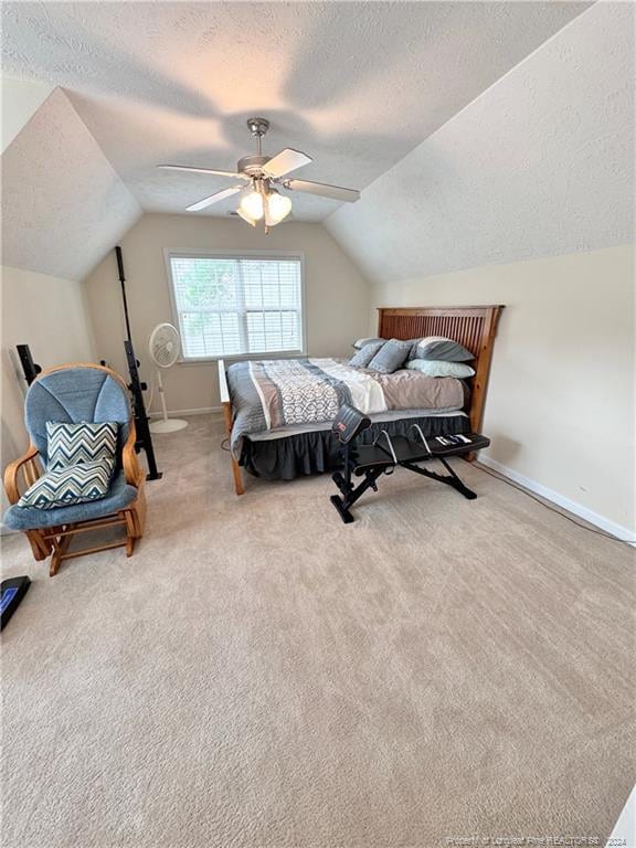 bedroom with lofted ceiling, a textured ceiling, ceiling fan, and carpet floors