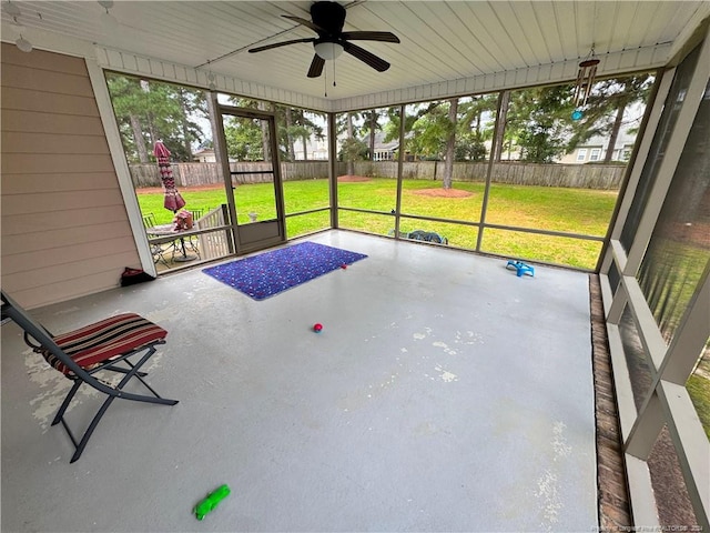 unfurnished sunroom featuring ceiling fan