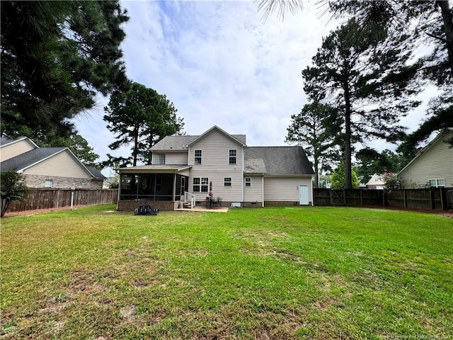 rear view of house with a patio area, a sunroom, and a lawn