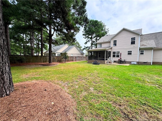 view of yard with a sunroom and a patio