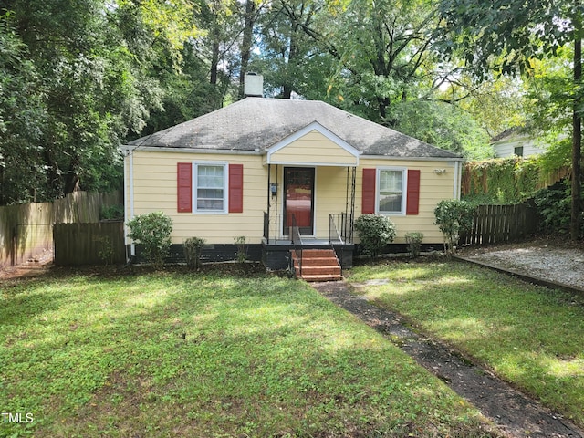 bungalow with a front lawn and covered porch