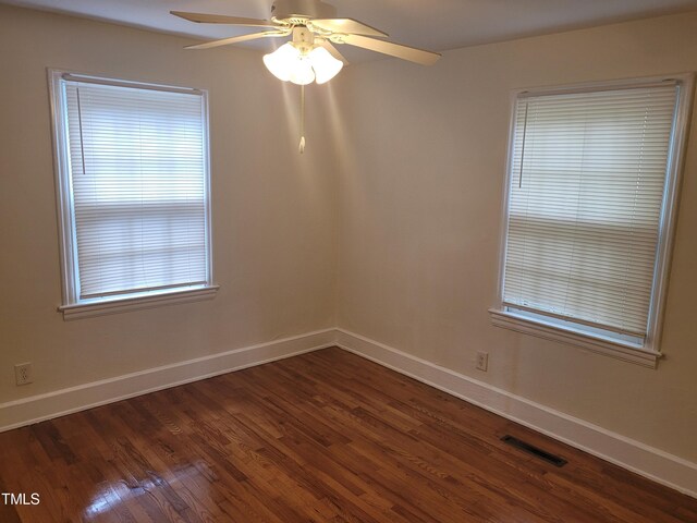 unfurnished room featuring dark hardwood / wood-style floors and ceiling fan