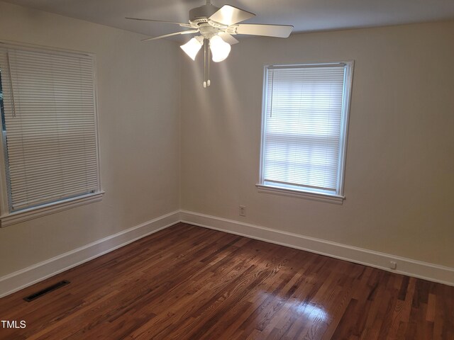 spare room with ceiling fan and dark hardwood / wood-style floors