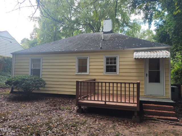 rear view of property with a wooden deck