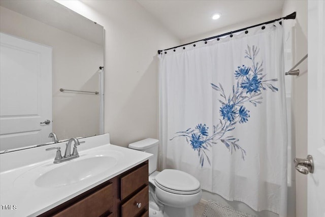 bathroom featuring vanity, toilet, and a shower with curtain