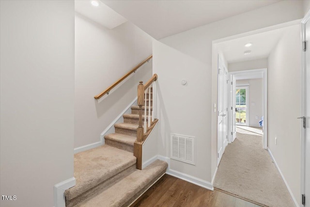 staircase featuring wood-type flooring