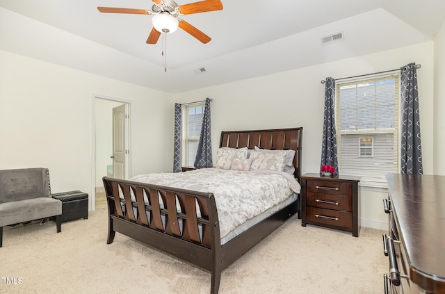 bedroom featuring multiple windows, light carpet, and ceiling fan