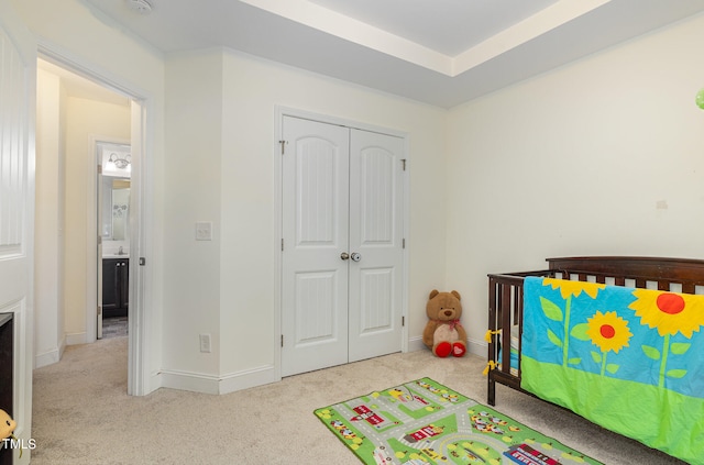 bedroom with light carpet and a closet