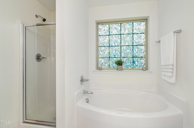 bathroom featuring separate shower and tub