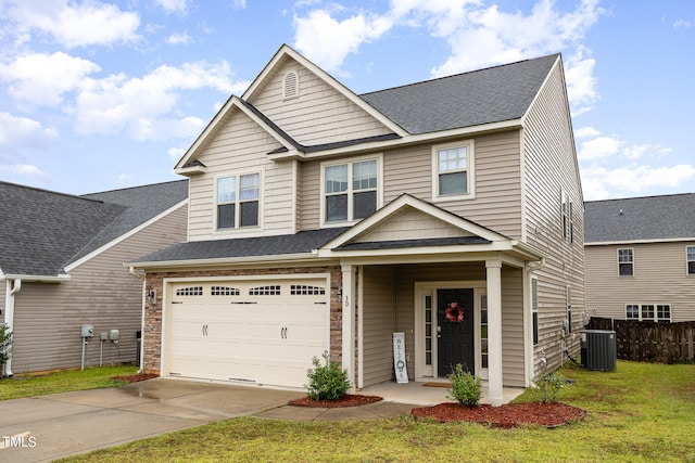 craftsman inspired home with a front yard, central air condition unit, and a garage