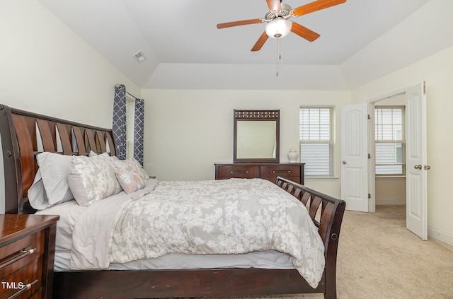 bedroom featuring light carpet, lofted ceiling, and ceiling fan