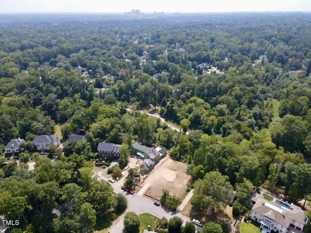 birds eye view of property featuring a view of trees