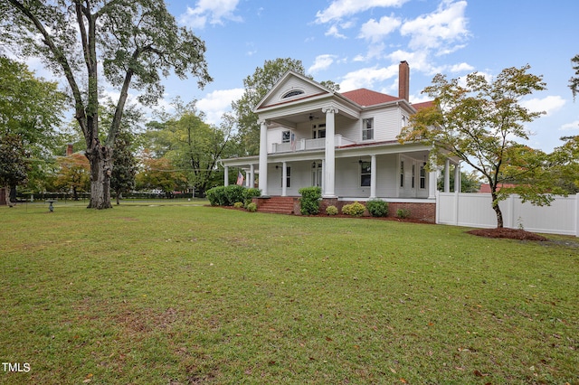 neoclassical / greek revival house featuring a front lawn and covered porch