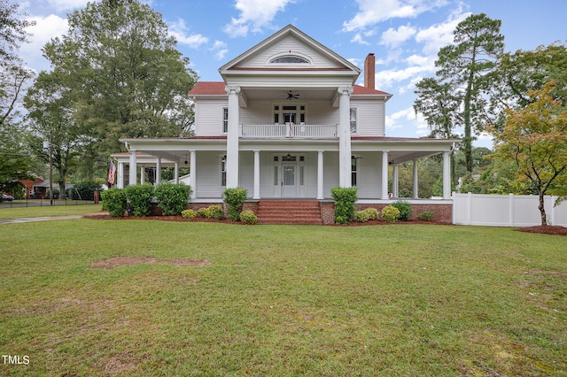 greek revival inspired property with a porch, a front lawn, and ceiling fan