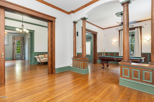 interior space with wood-type flooring, decorative columns, and a wealth of natural light