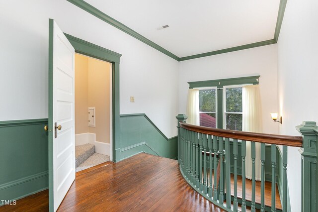 hall with hardwood / wood-style floors and crown molding