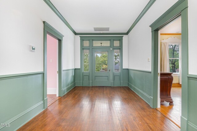 entryway featuring crown molding, hardwood / wood-style floors, and a wealth of natural light