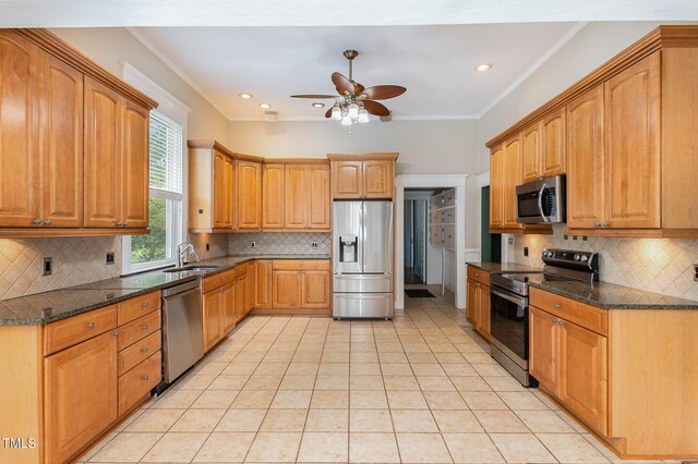 kitchen featuring stainless steel appliances, ceiling fan, and tasteful backsplash