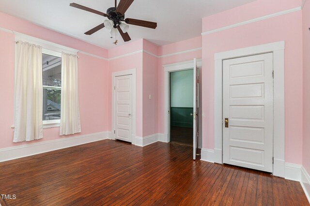 unfurnished bedroom with ceiling fan and dark hardwood / wood-style floors