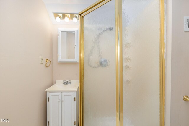 bathroom featuring vanity and an enclosed shower