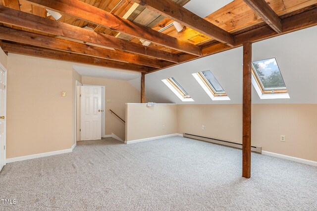 bonus room with wood ceiling, a baseboard heating unit, light carpet, and vaulted ceiling with skylight