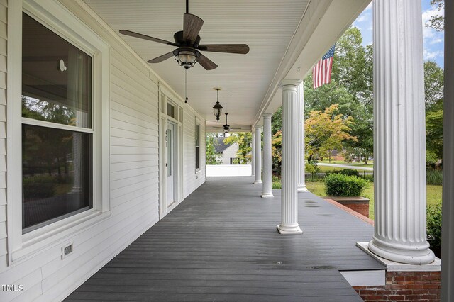 wooden terrace with ceiling fan and a porch