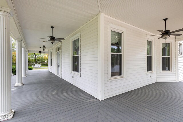 wooden deck featuring covered porch and ceiling fan