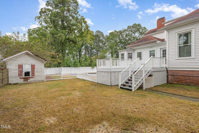 view of yard featuring a wooden deck and a shed