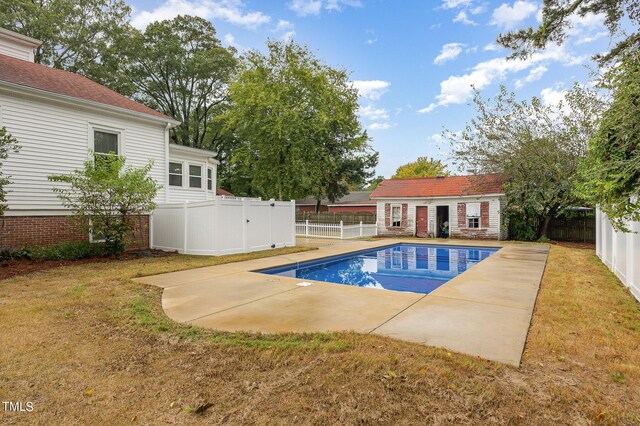 view of swimming pool featuring a lawn and a patio