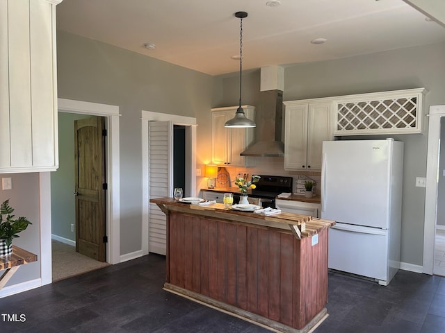 kitchen with wall chimney range hood, black electric range, dark hardwood / wood-style floors, white refrigerator, and pendant lighting