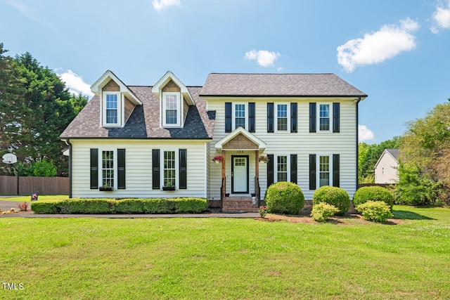 colonial house featuring a front lawn