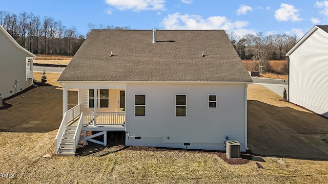 rear view of house featuring central AC unit and a porch