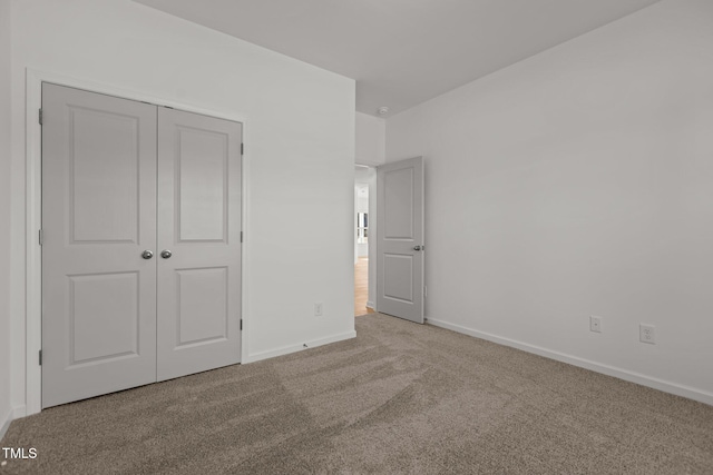 unfurnished bedroom featuring carpet floors and a closet