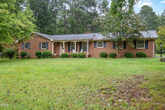 single story home with a porch and a front lawn