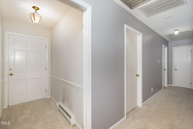 hall with light colored carpet and baseboard heating