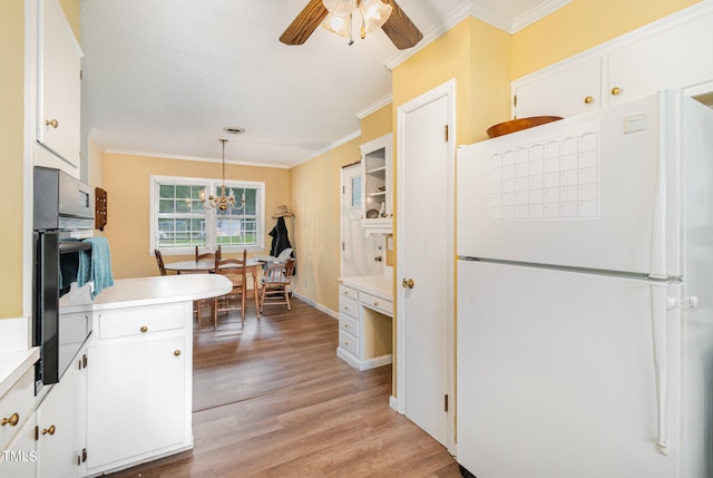 kitchen with light wood-type flooring, decorative light fixtures, white cabinetry, ceiling fan with notable chandelier, and white fridge