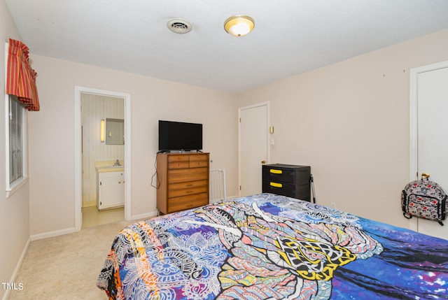 carpeted bedroom with radiator and ensuite bathroom