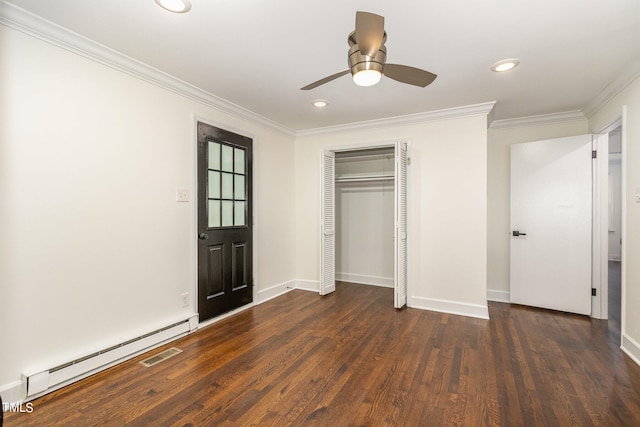 unfurnished bedroom with ceiling fan, baseboard heating, dark hardwood / wood-style flooring, a closet, and ornamental molding