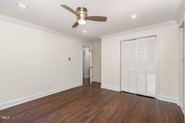 unfurnished bedroom featuring dark hardwood / wood-style flooring, a closet, ceiling fan, and crown molding