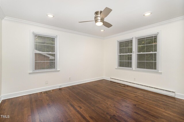 spare room featuring crown molding, ceiling fan, dark hardwood / wood-style floors, and a baseboard heating unit