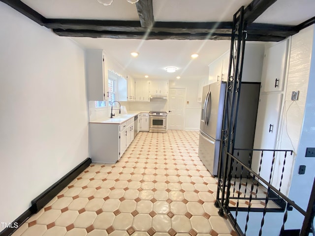 kitchen featuring sink, beamed ceiling, appliances with stainless steel finishes, white cabinets, and ornamental molding