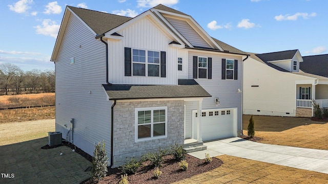 view of front of house featuring central AC unit and a garage